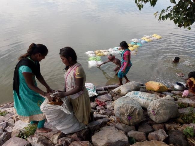 बाढ़ के पानी में दो किलोमीटर तैर कर मकई ला रहे है किसान