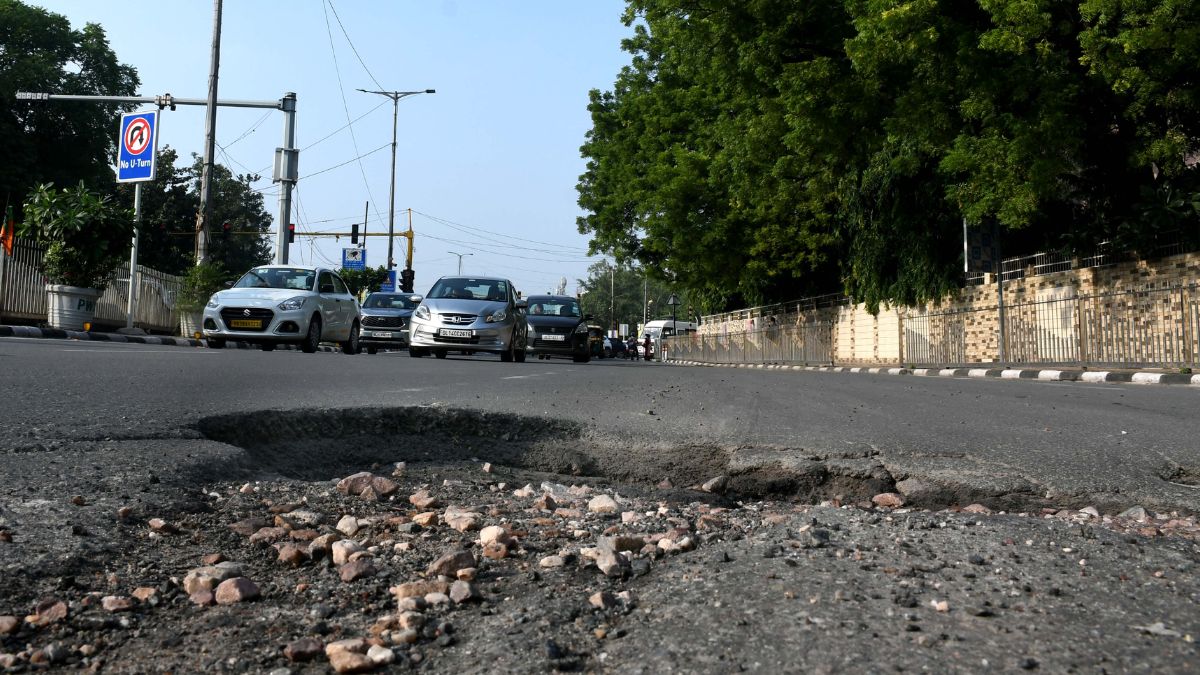 delhi roads potholes cause traffic jams vehicle damage and accidents