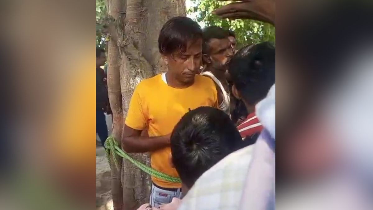viral video two men tied to tree and beaten accused of battery theft