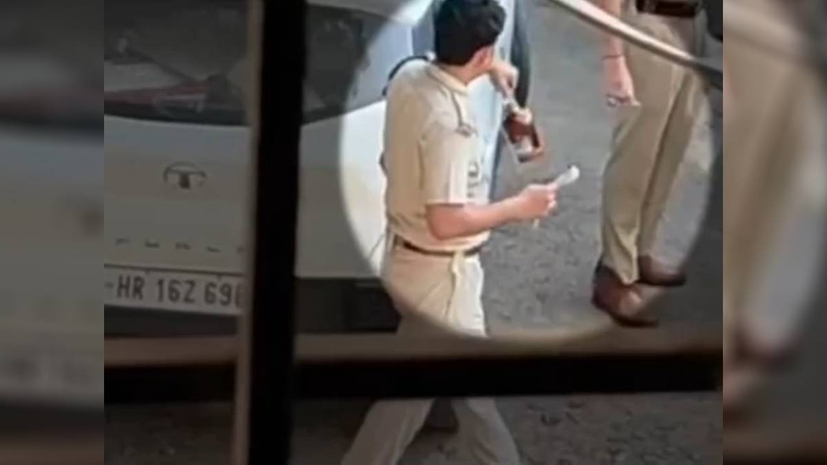 video of sho holding liquor bottle while distributing sweets to policemen on diwali goes viral investigation launched