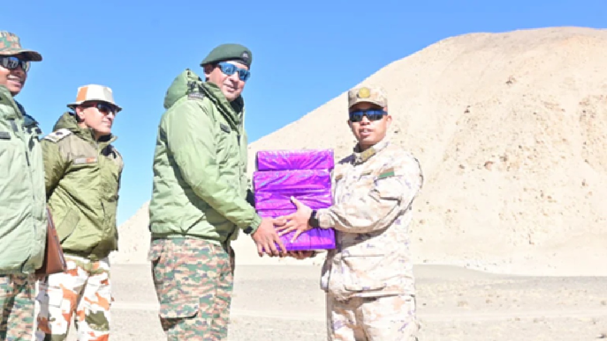 indian and chinese soldiers exchange sweets on diwali