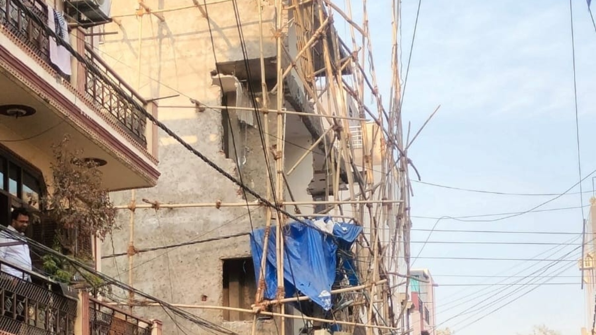 delhi tilting building demolition starts in rohini sector 7