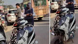 जिला ऊना के अंब में स्कूटी राइडर का चालान करती पुलिस। जागरण