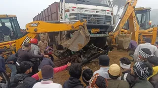 ट्रक के नीचे दबी ई-रिक्शा