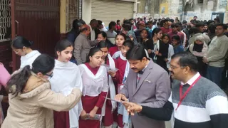 चित्रगुप्त इंटर कालेज में यूपी बोर्ड परीक्षा देने आये विद्यार्थियों की तलाशी के दौरान प्रवेश पत्र चेक करते शिक्षक।