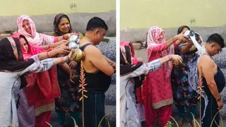 बीबी नगर में युवक के साथ लोटा मार होली खेलती महिलाएं। जागरण