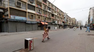 पाकिस्तान में सड़क पर क्रिकेट खेलते हुए लोग। (फोटो सोर्स - रॉयटर्स)
