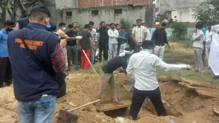 मेरठ में कब्र से शव निकलवाती पुलिस।
