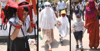 बच्चे को कपड़े से ढक कर ले जाते अभिभावक । जागरण