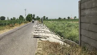 पुसार बरनावा मार्ग पर बेगमाबाद गढ़ी व मांगरौली के बीच टूटी पड़ी खेत की बाउंड्री वाल। जागरण