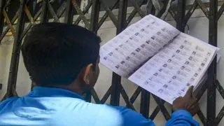 बूथ पर वोटर लिस्ट में अपना नाम चेक करता मतदाता। (प्रतीकात्मक फोटो)