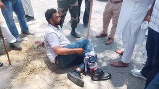 फायरिंग के बीच घायल युवक।