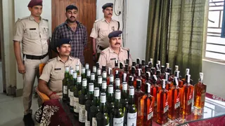 आनंद विहार -मुजफ्फरपुर सप्तक्रांति सुपर फास्ट एक्सप्रेस ट्रेन बरामद शराब की जानकारी देते पदाधिकारी।