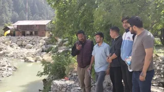 हर्षिल में भागीरथी नदी का जलस्तर बढ़ने से उत्पन्न खतरे का जायजा लेते आपदा प्रबंधन अधिकारी व अन्य। स्रोत सूचना विभाग