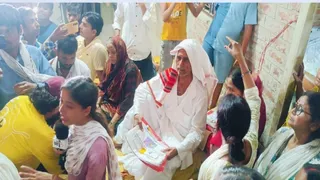 जवइनिया गांव के कटाव पीड़ितों के बीच वस्त्र वितरित करते भरत तिवारी के पिता काशीनाथ तिवारी