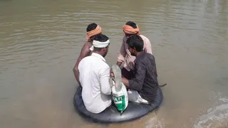 माननगर घाट पर ट्यूब के सहारे नदी पार करते किसान।