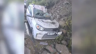 पोखरी-मोहनखाल सड़क किनारे खड़ी कार के ऊपर बोल्डर आने से क्षतिग्रस्त कार। जागरण