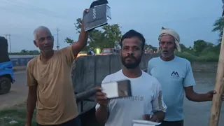 बुलंदशहर की नहर से मिले मोबाइल फोन दिखाते ग्रामीण।
