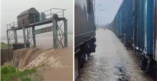चित्रकूट में बांध के ऊपर से गुजरता पानी और मुंबई हावड़ा रेलवे ट्रैक पर पानी भरने से खड़ी ट्रेनें। वीडियो ग्रैब