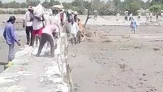 बिजनौर में तटबंध बनाने में जुटे ग्रामीण।