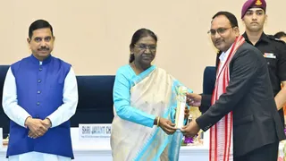 राष्ट्रपति द्रौपदी मुर्मु से सम्मानित होते शिक्षक शैलेंद्र सिंह (दाएं) व बाएं खड़े मंत्री प्रहलाद जोशी।