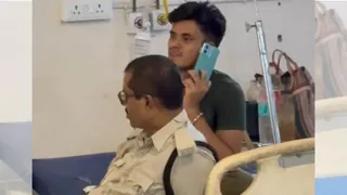 डीएमसीएच में मोबाइल से बात करते बंदी, बगल में बैठी सुरक्षा में जवान। सौजन्य वीडियो क्रेब
