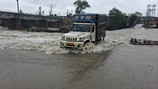नामकुम स्थित स्वर्ण रेखा नदी के ऊपर से सड़क पर बहता पानी। (फोटो: संजय सुमन)