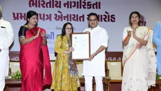 उपमुख्यमंत्री हर्ष संघवी भारत की नागरिकता का प्रमाण पत्र सौंपते हुए।