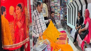 रामपुर मनिहारान में कपड़े की दुकान पर डमी पर लगा करवा चौथ स्पेशल सूट और सूट देखती महिलाएं। जागरण