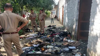 प्रयागराज के थरवई स्थित पं. हनुमत त्रिपाठी इंटर कॉलेज में आग से जले सामान की जांच करती पुलिस। जागरण