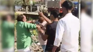 हरी शर्ट में अवर अभियंता की पिटाई करते दबंग
