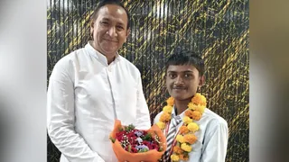 छात्र का उत्साहवर्धन करते प्रधानाचार्य