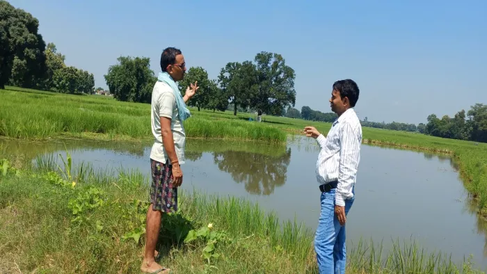 भगवानपुर पश्चिम गांव निवासी करुणेश प्रताप(बाएं)से जीरा,धान संग मछली पालन के बारे में पूछते मत्स्य वैज्ञानिक डा. प्रकाश चंद्र।