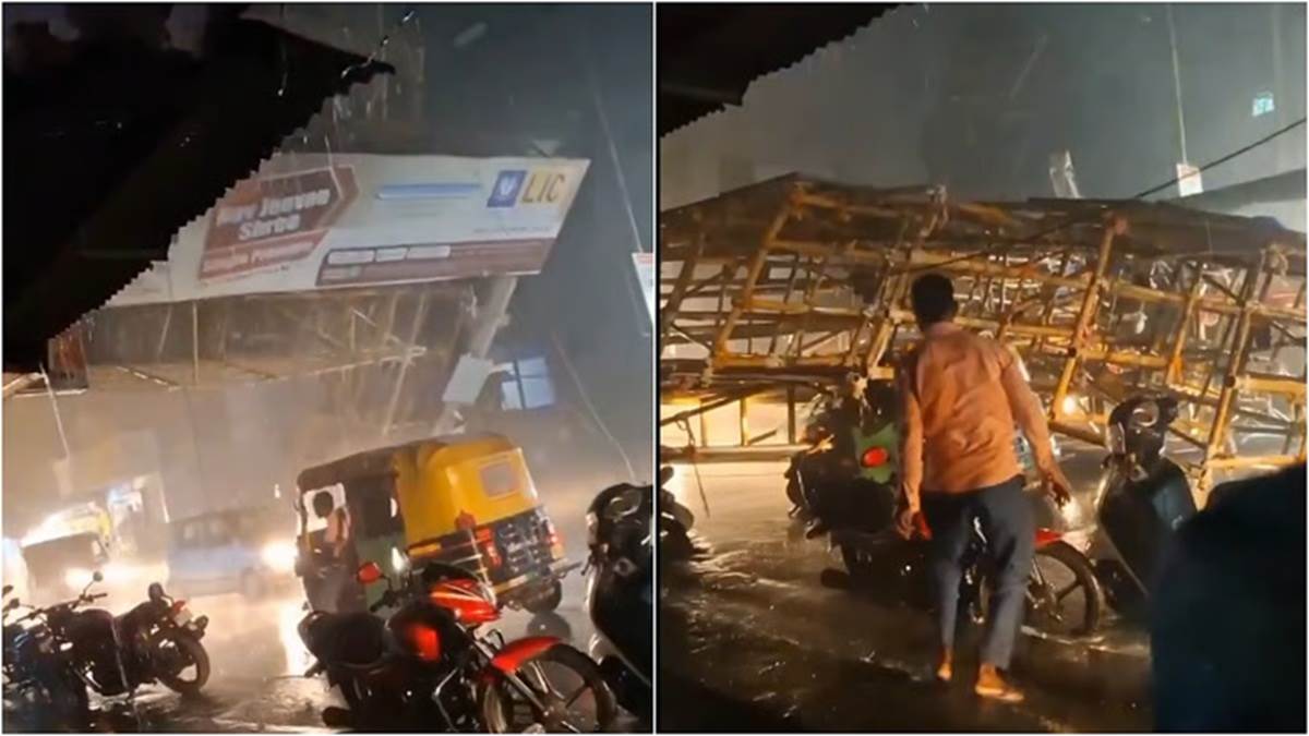 auto driver narrowly escapes as lic banner hoarding falls on him video viral