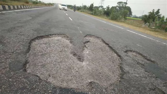 अलीगढ़ में दिल्ली-कानपुर राष्ट्रीय राजमार्ग में गड़्ढों के चलते आवागमन में परेशानी।
