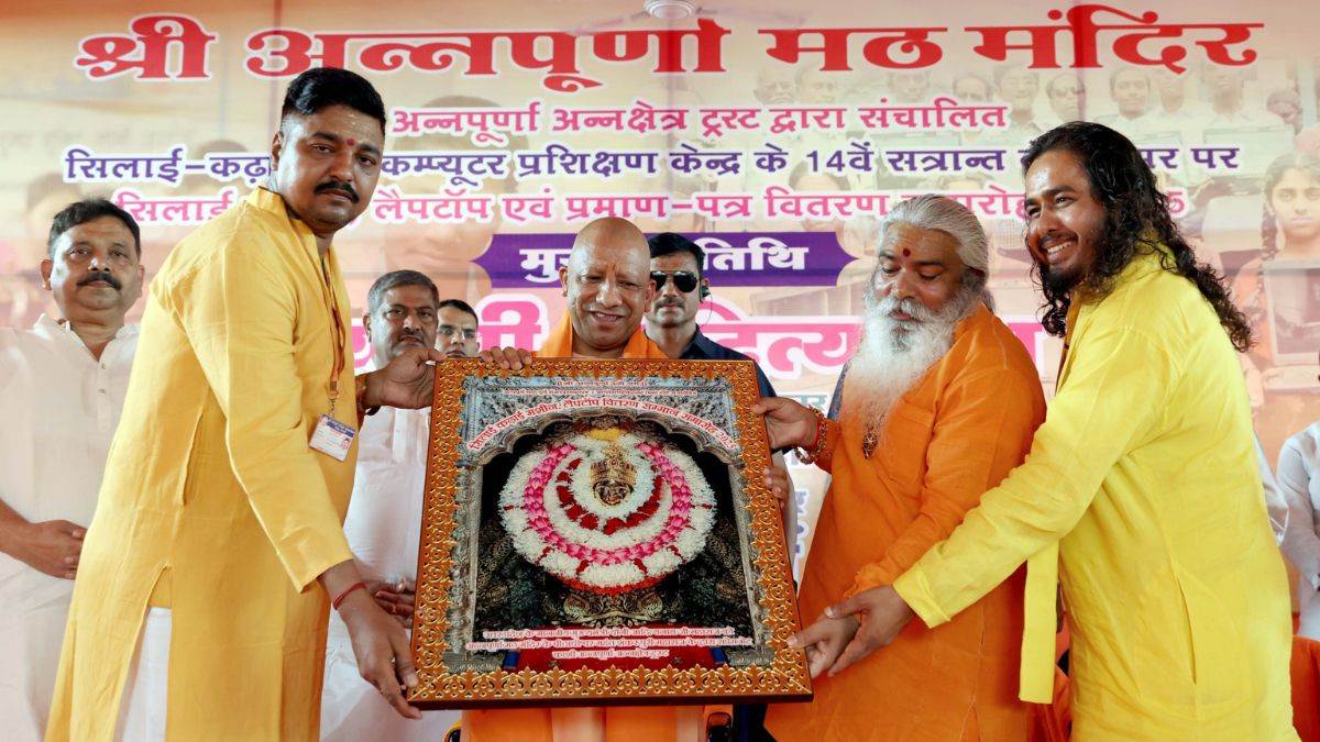 cm yogi adityanath promotes sanatan dharma distributes laptops and sewing machines