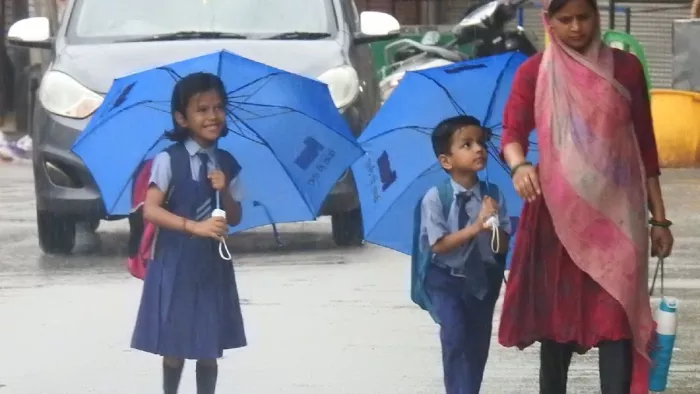 वर्षा में छाते का सहारा लेकर मां के साथ स्कूल जाते नौनिहाल। पंकज श्रीवास्तव
