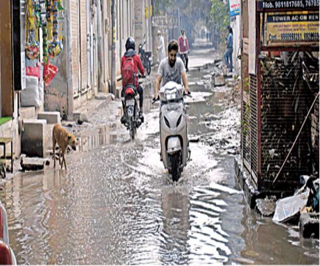छतरपुर एक्सटेंशन में नालियों का पानी सड़क पर भर गया है। जागरण