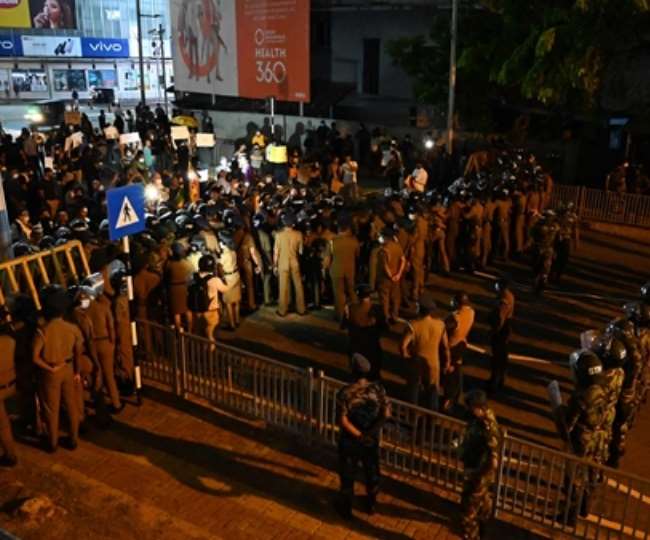 कोलंबो में प्रधानमंत्री आवास के प्रवेश मार्ग पर प्रदर्शनकारियों को रोकते सुरक्षा बल के जवान... (Photo AFP)