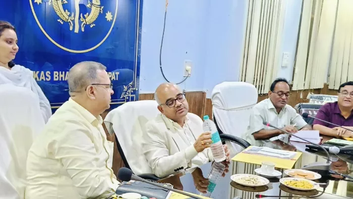 बागपत विकास भवन में पानी की बोतल में कंपनी का नाम पढ़ते डीएम जितेंद्र प्रताप सिंह। सौ. सूचना विभाग