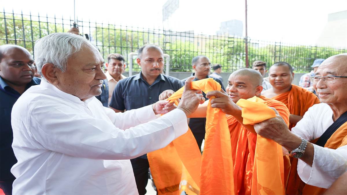 bihar chief minister nitish kumar sitting with buddhist monks near the tree brought from sri lanka bjp leader samrat choudhary and vijay sinha were also there
