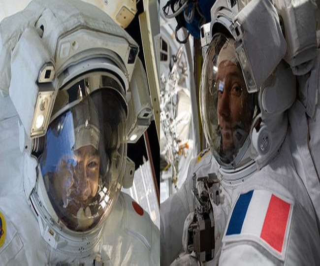 two astronauts venture outside the space station on a spacewalk