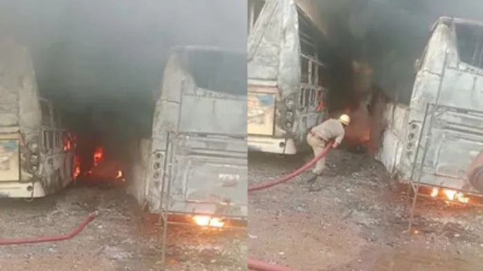 बसों में लगी आग को बुझाते दमकल कर्मचारी।