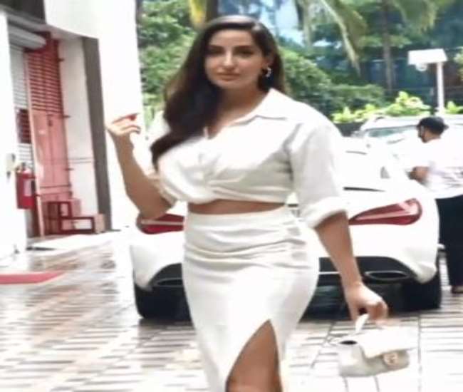 Nora Fatehi spotted outside an office, glamorous look in white dress. photo source @viralbhayani instagram.