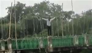 पुल पर चढ़ तालाब में कूदने की धमकी देता रहा युवक।