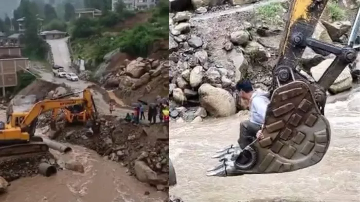 जिला मंडी के थुनाग में जेसीबी मशीन पर नाला पार करते अधिकारी।