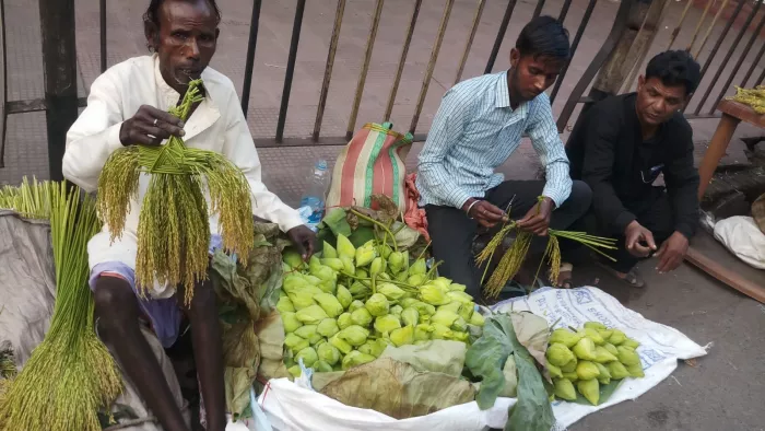 साकची बाजार में सजी फूल मालाएं। खरीदारी करते लोग।