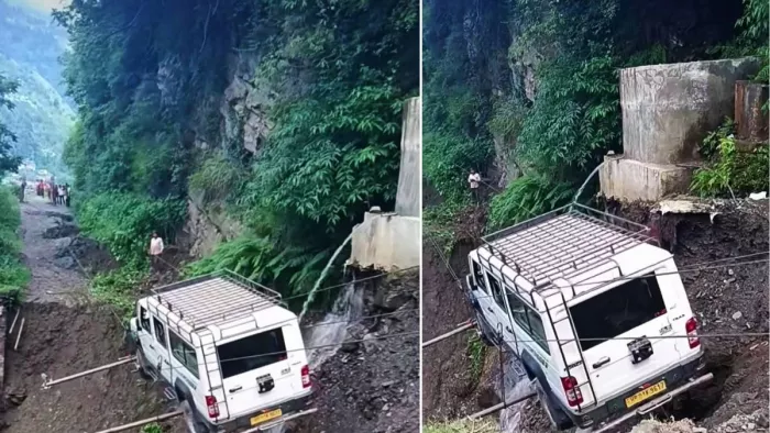 जिला कुल्लू के लगघाटी में सड़क टूटने के कारण तार स्पैन से गाड़ी को निकालते लोग।