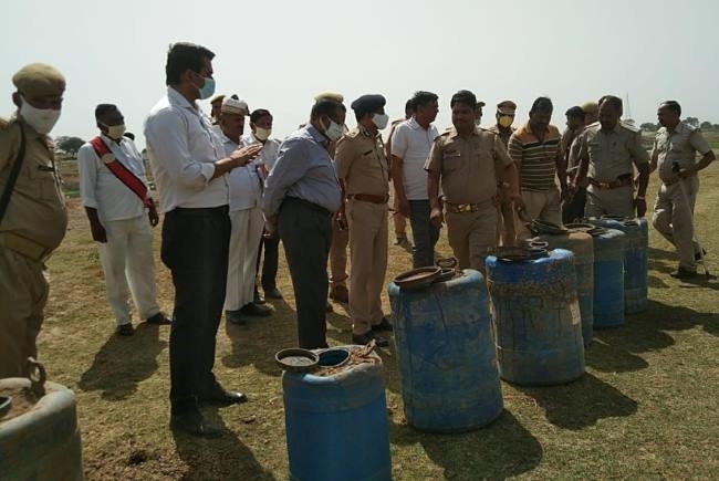 illegal raw liquor and boiling found buried in river bank beat constable suspended