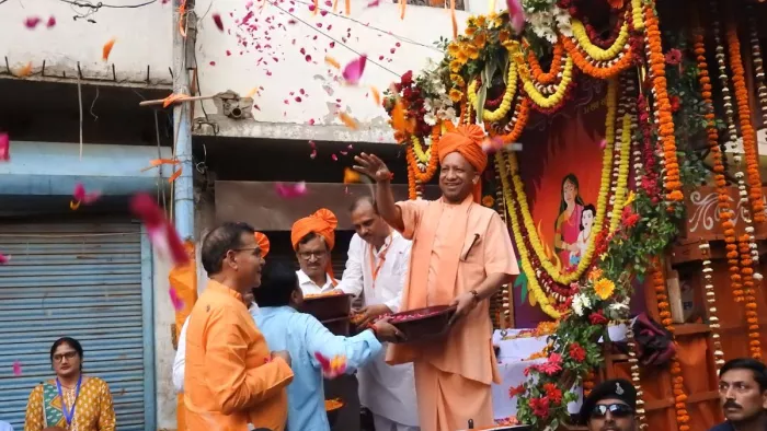 होलिका दहन शोभायात्रा में भक्त प्रहलाद की आरती करने के बाद उपस्थित लोगों पर पुष्पवर्षा करते मुख्यमंत्री योगी आदित्यनाथ।